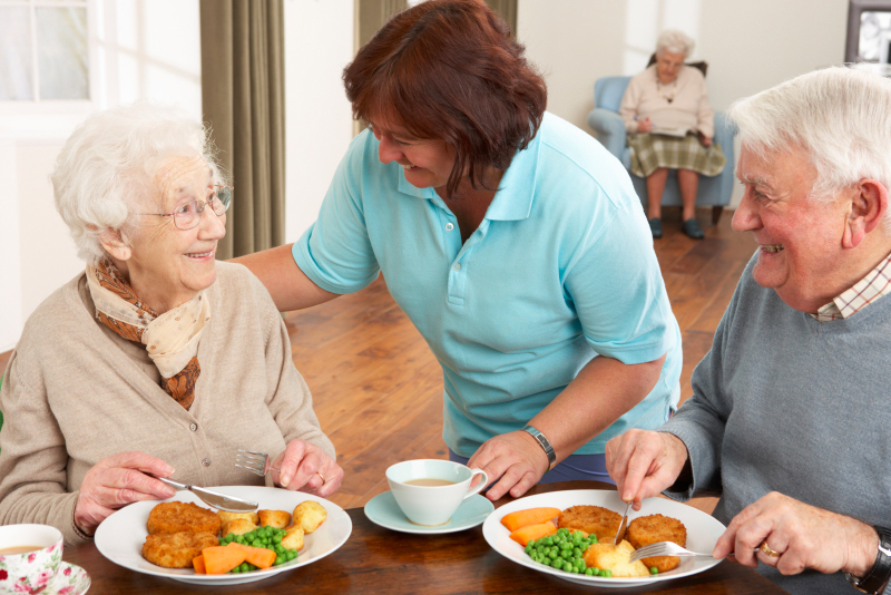 carer with older patients with food